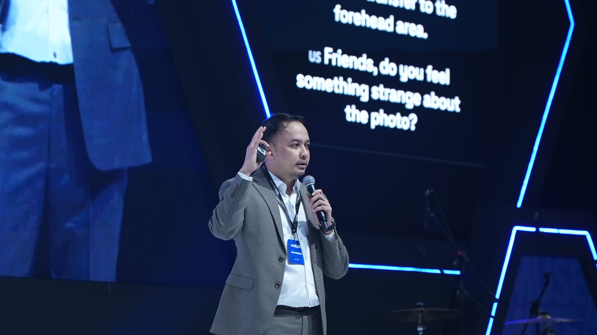 Dr. Danu speaking on stage with a microphone at a medical congress