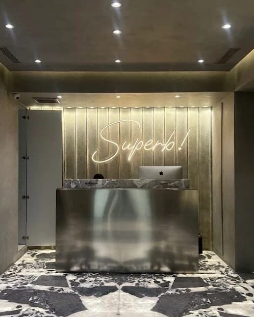 SUPERB Clinic reception with the Superb! neon sign